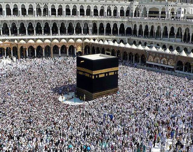 A sea of people circumambulate the Kaabah (black cube structure)