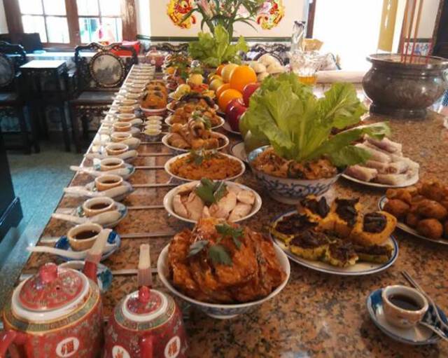 Photo of food offerings on a table. Vegetarian food prepared for ancestor worship during the Tomb-Sweeping Day in a vegetarian hall in pre-Covid Singapore